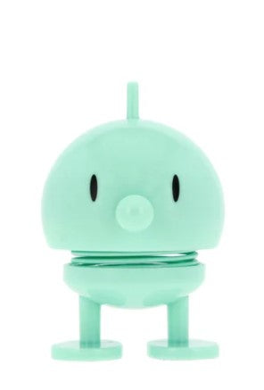 A mint cartoon-like character statue on a white background