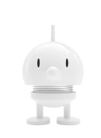 A white cartoon-like character statue on a white background