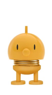 Yellow cartoon-like character statue on a white background.
